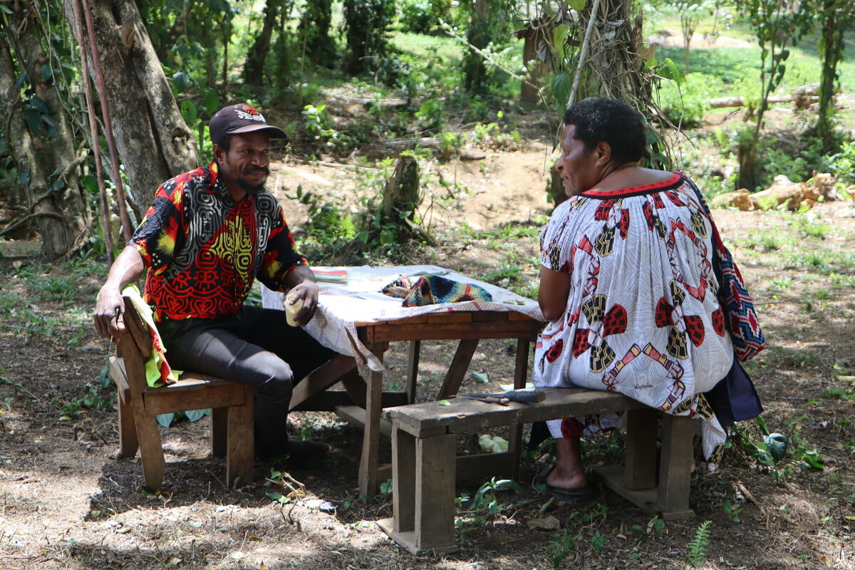 Regina speaking with a member of the community in Sololo.